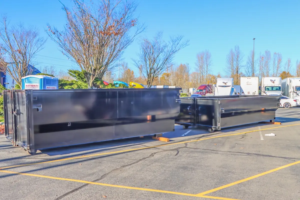 Professional dumpster rental service with roll-off container on residential driveway in Crown Point